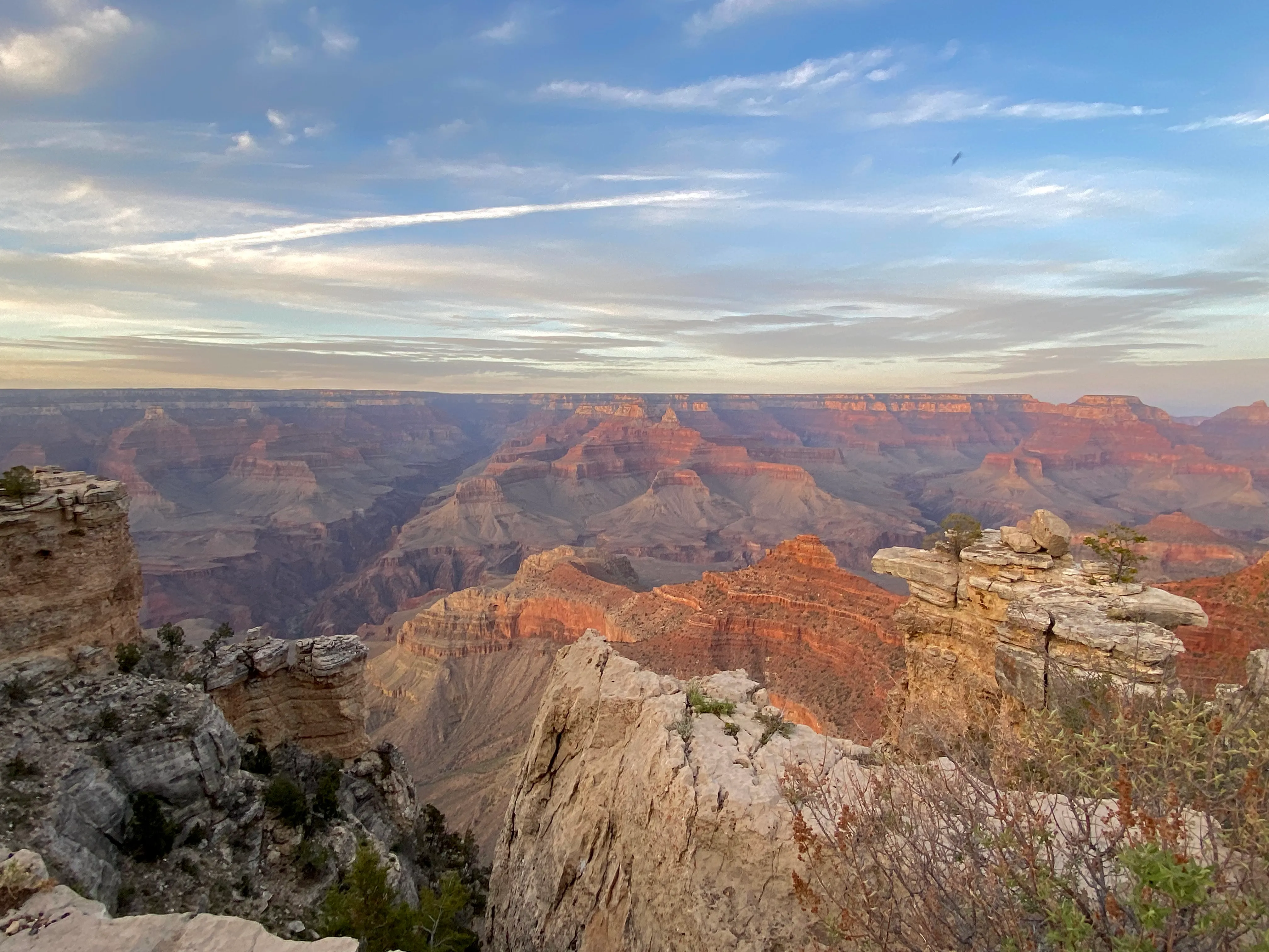 The layered red-rock cliffs of the Grand Canyon lit by evening light