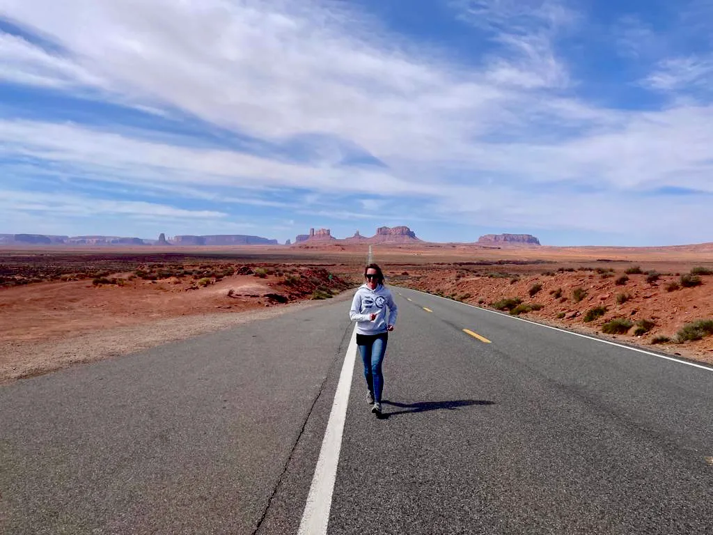 Running down the empty highway at Forrest Gump Point with Monument Valley’s buttes ahead