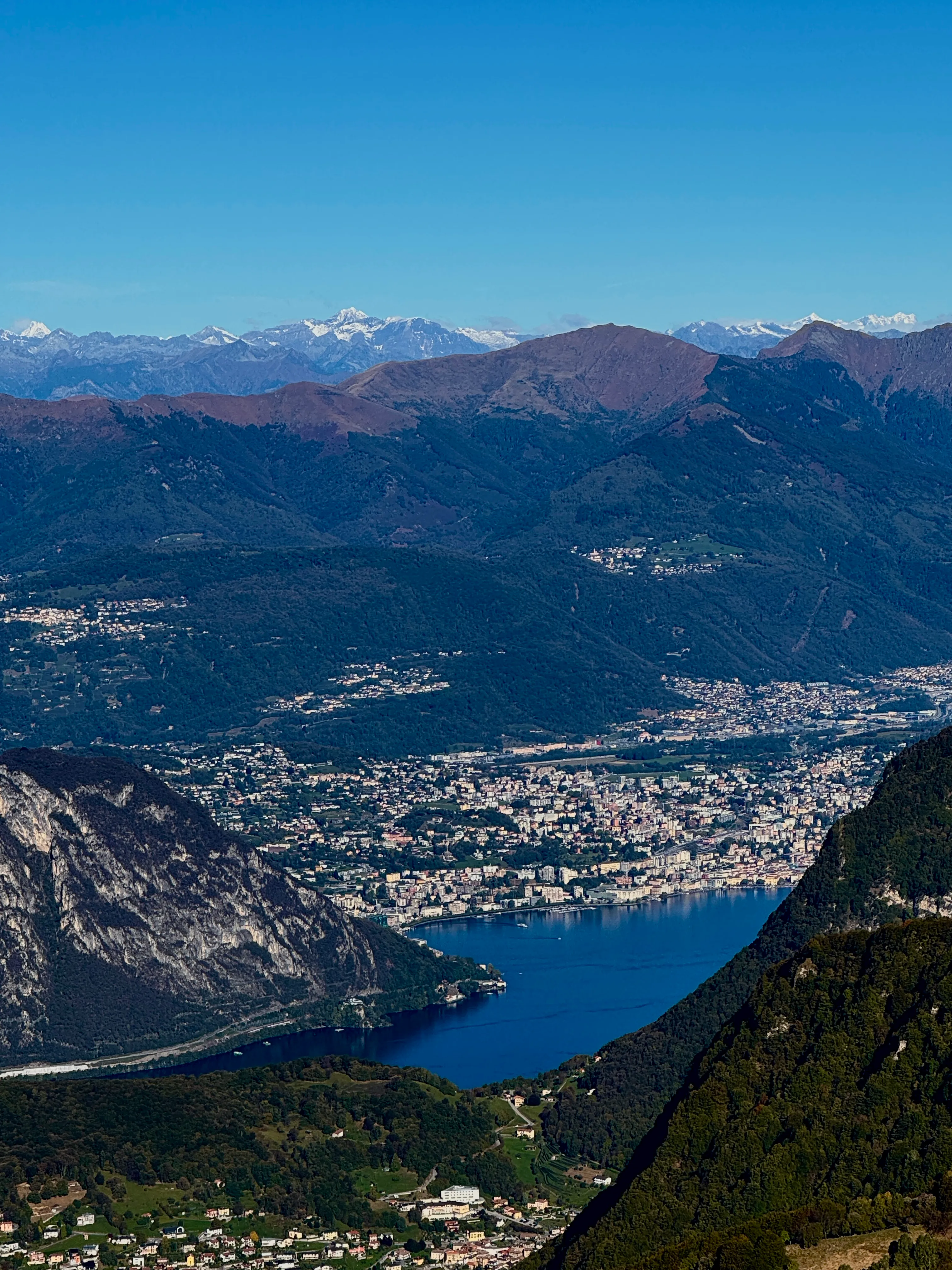 View of Lugano and its lake from Monte Generoso, with the snow-capped Alps behind