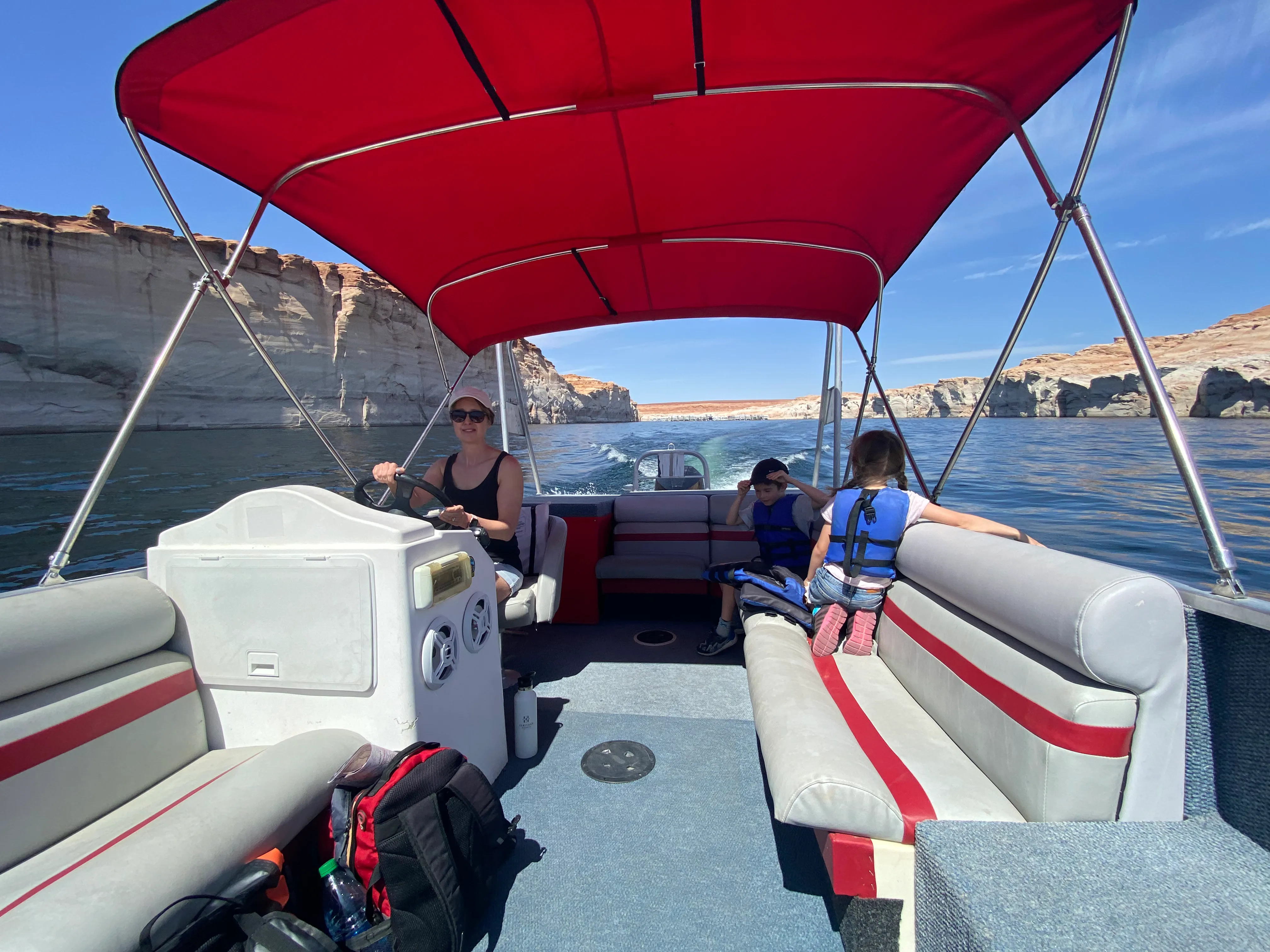 The family on a rented motorboat exploring Lake Powell’s red rock canyons