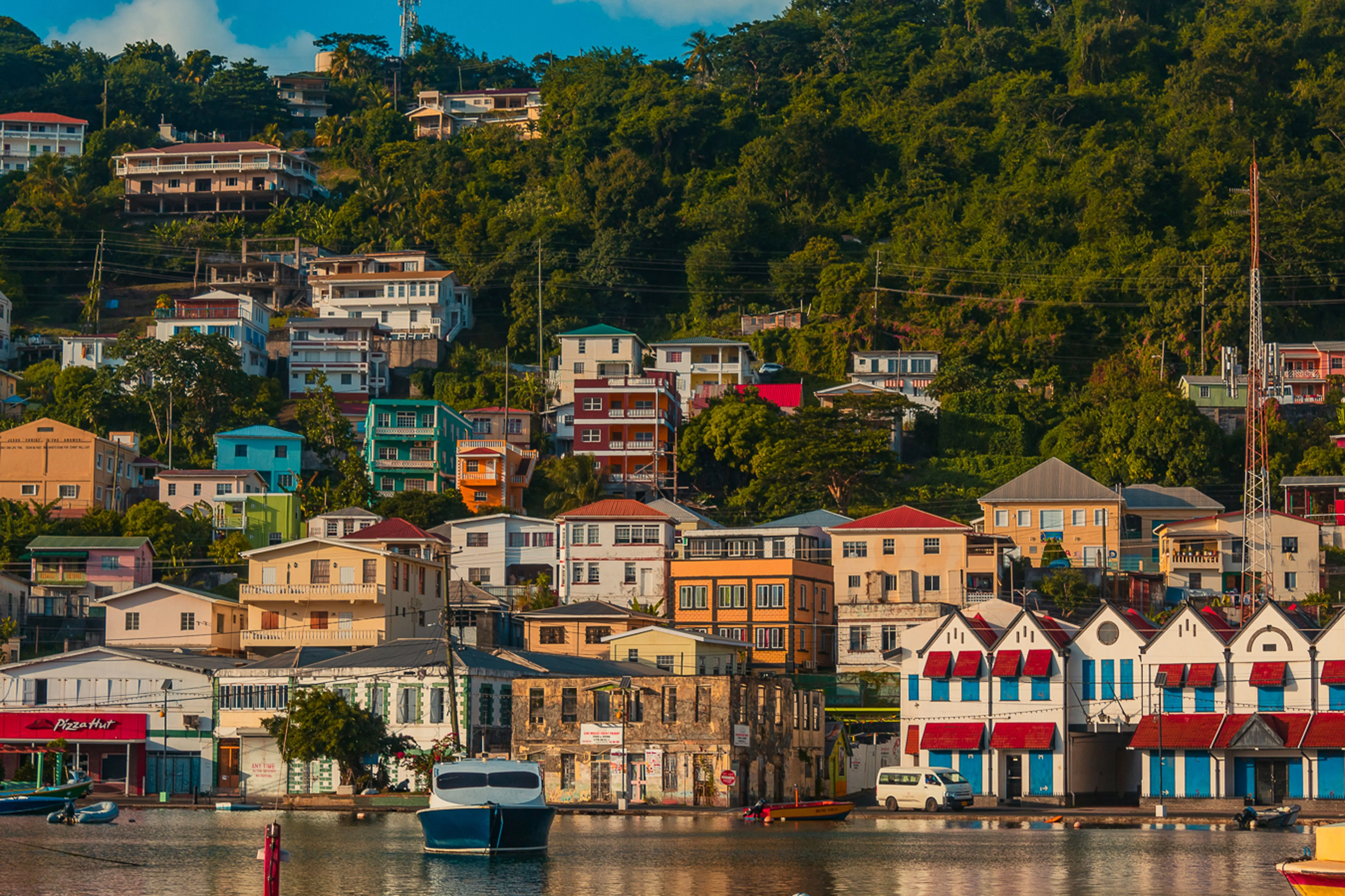 The coloured rooftops of St George’s stacked up the hillside above the harbour in Grenada