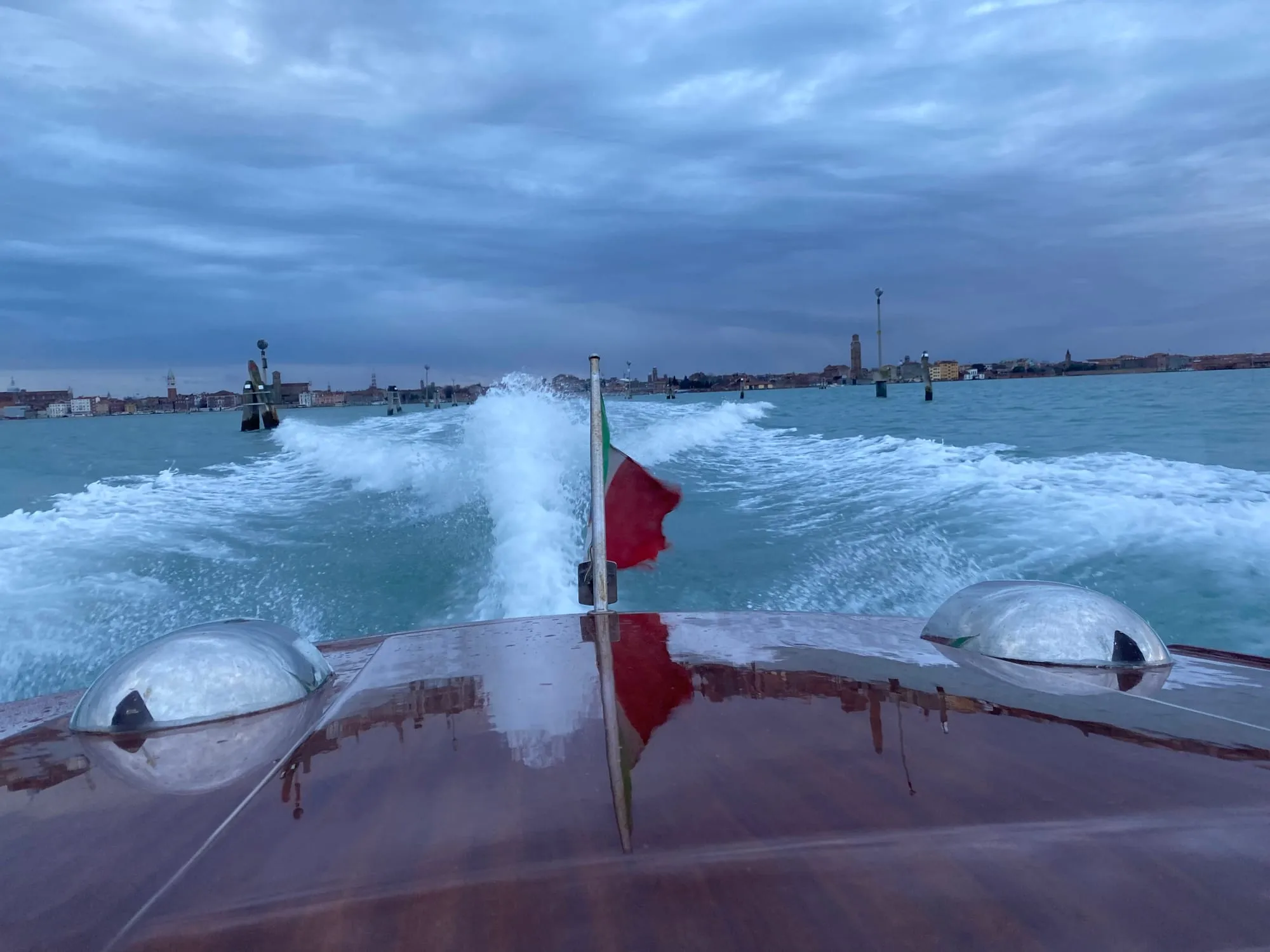 View from a speeding water taxi crossing the Venice lagoon towards the city skyline